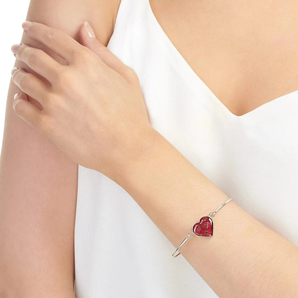 Poppy bangle with real flowers by  Shrieking Violet® Sterling silver heart bangle with tiny Euphorbia flowers. Includes giftbox.